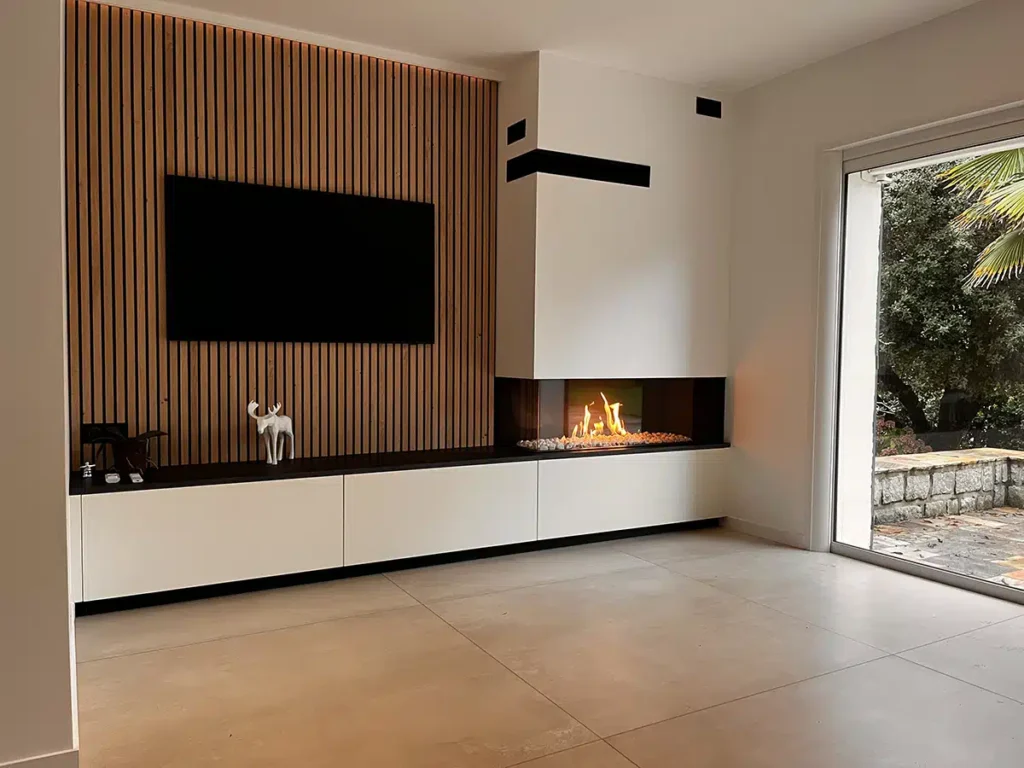 Cheminée gaz d'angle au design contemporain offrant une vue panoramique sur les flammes, réalisation Cheminées Nicolas.